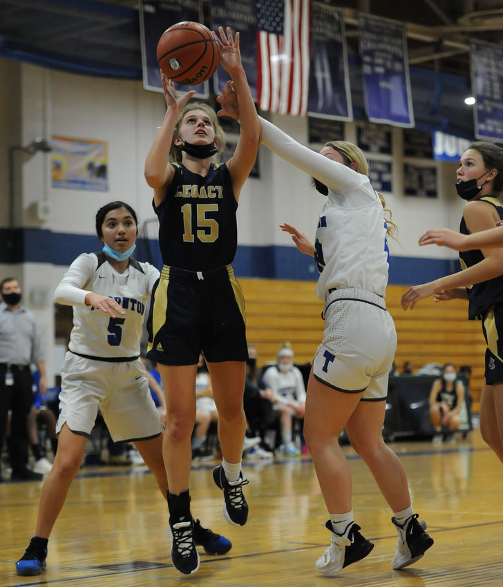 Legacy's Paityn Holstrom gets a shot off against Thornton's Araya William, right, Jan. 7 at Thornton High School. At left is the Thornton's Jewels Sandoval. The Lightning won easily 61-8.